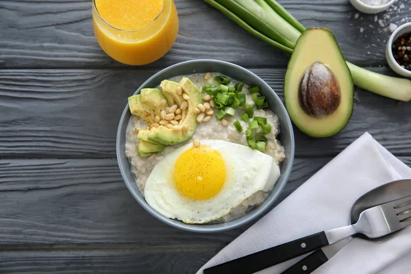 Bowl Delicious Oatmeal Egg Avocado Wooden Table — Stock Photo, Image