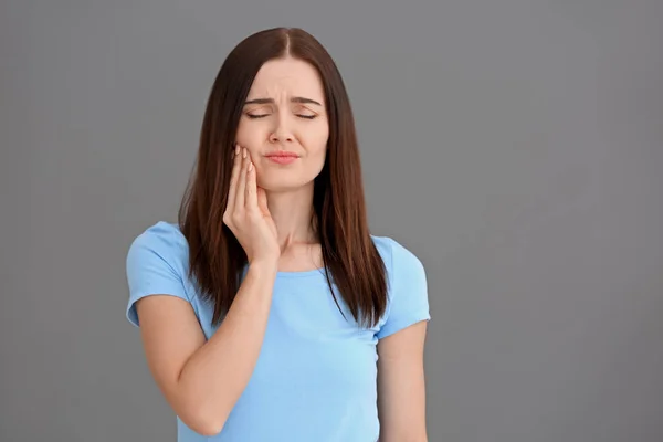 Young Woman Suffering Toothache Grey Background — Stock Photo, Image