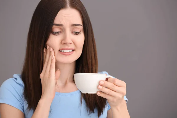 Young Woman Sensitive Teeth Cup Hot Coffee Grey Background — Stock Photo, Image