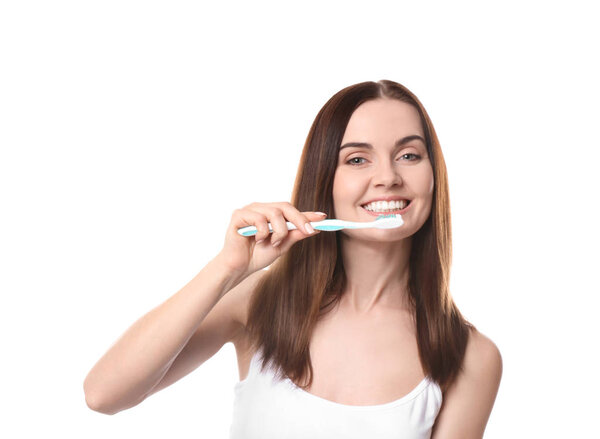 Beautiful young woman with toothbrush on white background