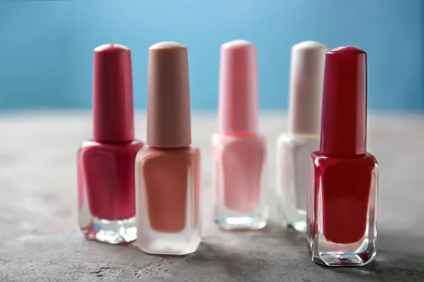 Bottles of colorful nail polishes on table