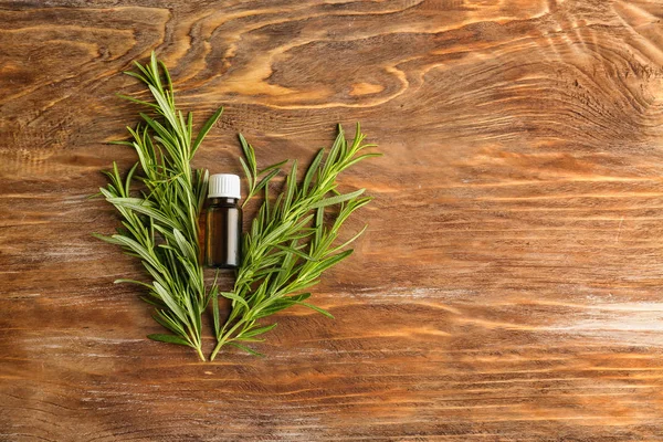 Fresh Rosemary Bottle Essential Oil Wooden Background — Stock Photo, Image