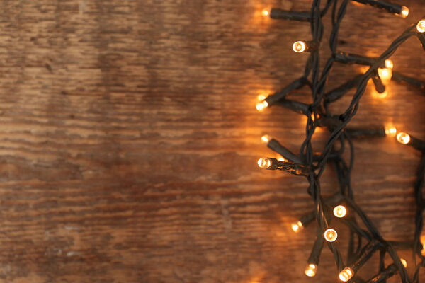 Festive Christmas garland on wooden background