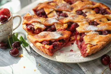 Ahşap masa üzerinde lezzetli ev yapımı kiraz pasta plaka