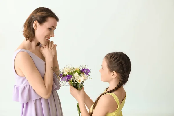 Little Girl Greeting Her Mother Bouquet Flowers Light Background — Stock Photo, Image