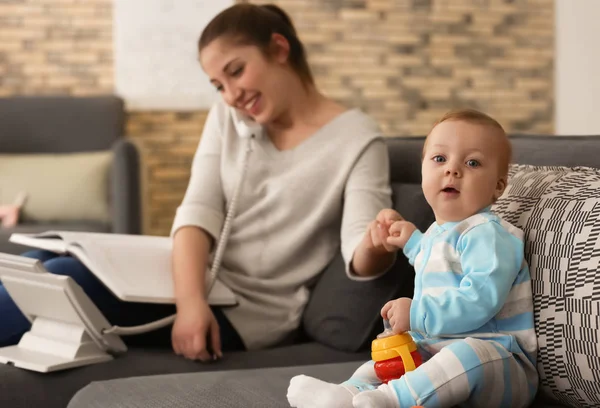 Cute Little Baby Sitting Sofa While Mother Working Home — Stock Photo, Image