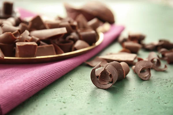 Delicious chocolate curls on table