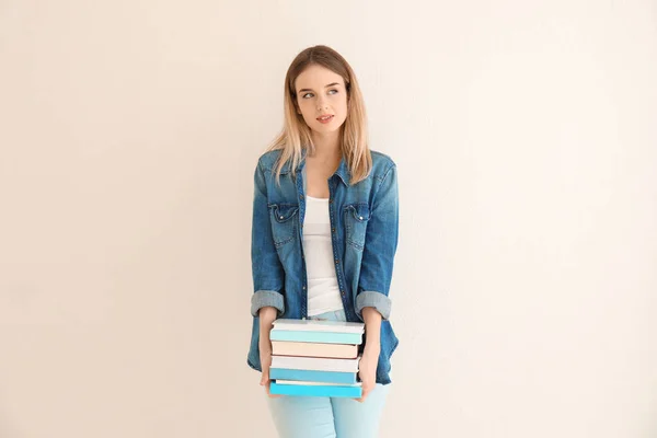 Young Woman Books Light Wall — Stock Photo, Image