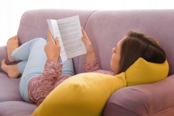 Jonge Vrouw Lezen Boek Bank Thuis — Stockfoto