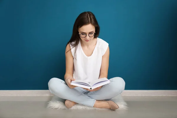 Giovane Donna Che Legge Libro Sul Pavimento Vicino Alla Parete — Foto Stock