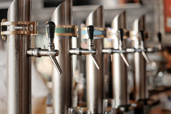 Draft beer taps in modern bar