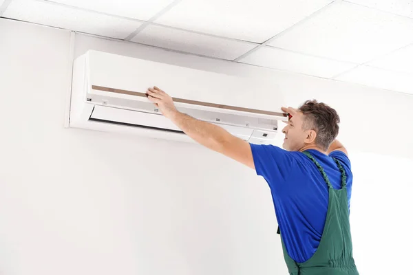 Mature Electrician Repairing Air Conditioner Indoors — Stock Photo, Image