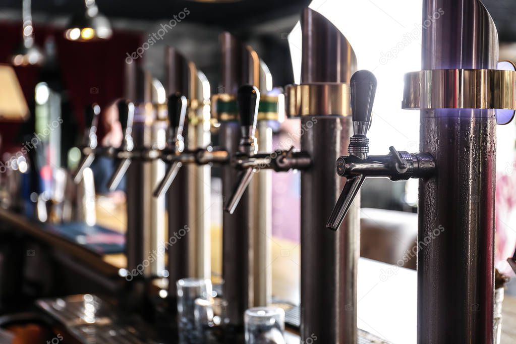 Draft beer taps in modern bar