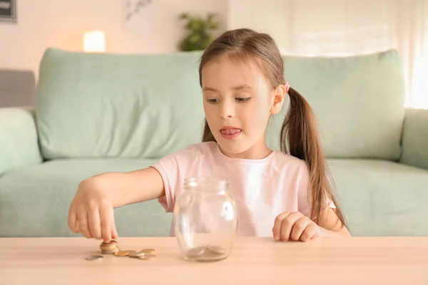 Little Girl Putting Coins Glass Jar Indoors Money Savings Concept — Stock Photo, Image