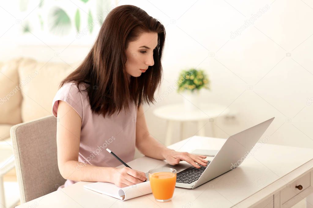 Young female freelancer working at home
