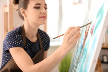 Atölyede resim yapan kadın sanatçı
