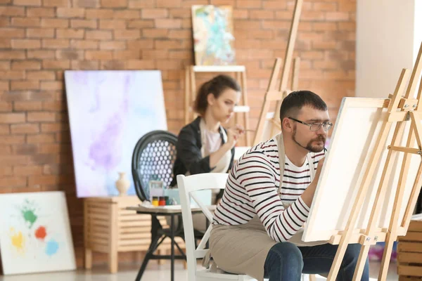 Male student during during classes in school of painters