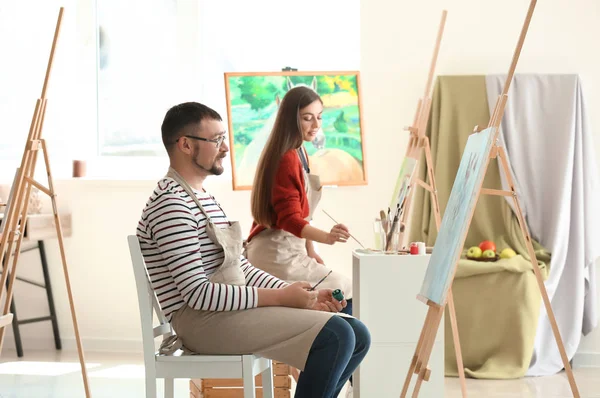 Group of people during classes in school of painters