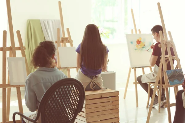 Group of people during classes in school of painters