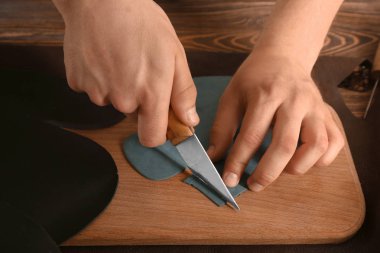 Adam kesme deri atölyesinde ahşap tahta üzerinde