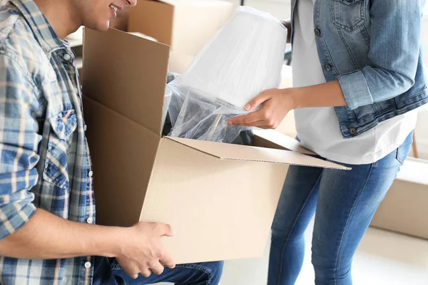 Young Couple Unpacking Box Indoors Moving New House — Stock Photo, Image