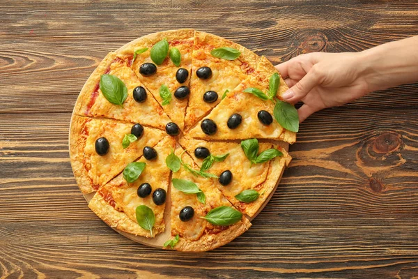 Woman Taking Slice Tasty Pizza Olives Wooden Table — Stock Photo, Image