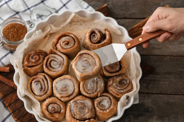 Woman Taking Tasty Cinnamon Bun Baking Dish — Stock Photo, Image