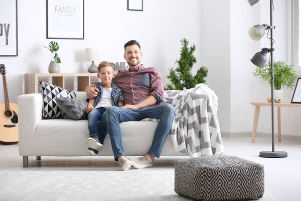 Little boy and his dad spending time together at home