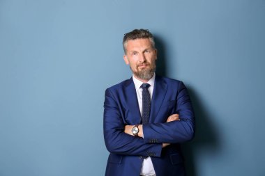 Renk arka plan üzerinde şık elbiseli Olgun yakışıklı