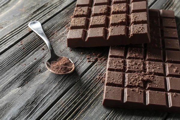 Tasty Milk Chocolate Bars Spoon Cocoa Powder Wooden Background — Stock Photo, Image