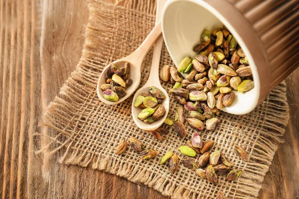 Bowl Spoons Fresh Tasty Pistachio Nuts Wooden Table — Stock Photo, Image