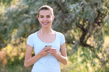 Cep telefonu müzik sonrası eğitim parkı olan güzel kadın