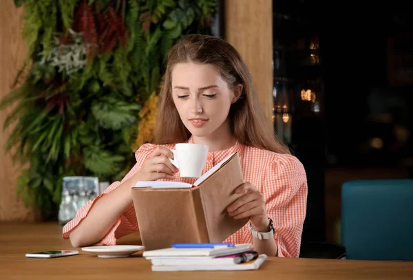 Young Woman Drinking Coffee While Reading Book Cafe — Stock Photo, Image