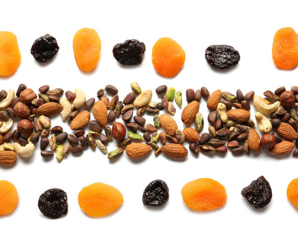 Composition with different nuts and dried fruits on white background