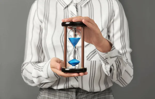 Woman Holding Hourglass Grey Background Time Management Concept — Stock Photo, Image