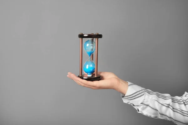 Woman Holding Hourglass Grey Background Time Management Concept — Stock Photo, Image