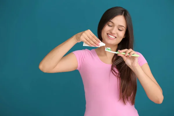 Young Woman Squeezing Toothpaste Brush Color Background — Stock Photo, Image