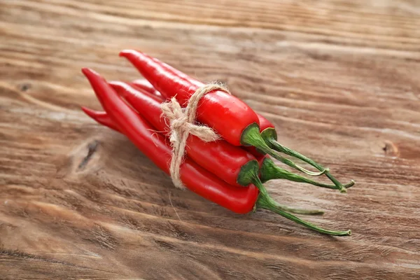 Tied Fresh Chili Peppers Wooden Background — Stock Photo, Image