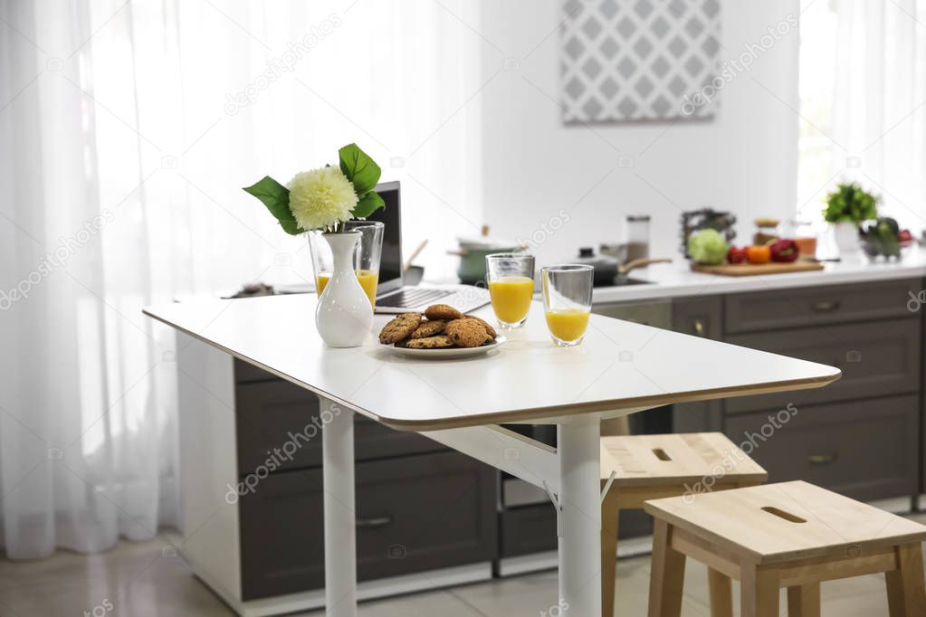 Big white table on stylish kitchen
