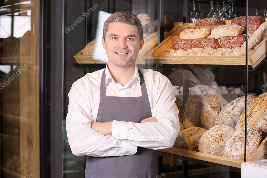 Portrait of happy worker in bakery shop