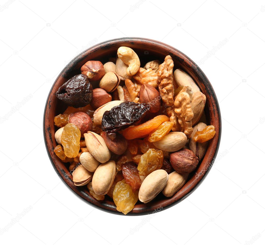 Bowl with different nuts and dried fruits on white background