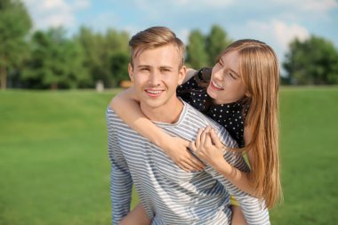 Güneşli günde Park'ta yürüyordunuz genç çift
