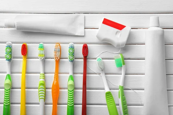 Toothbrushes Dental Floss Paste White Wooden Background — Stock Photo, Image