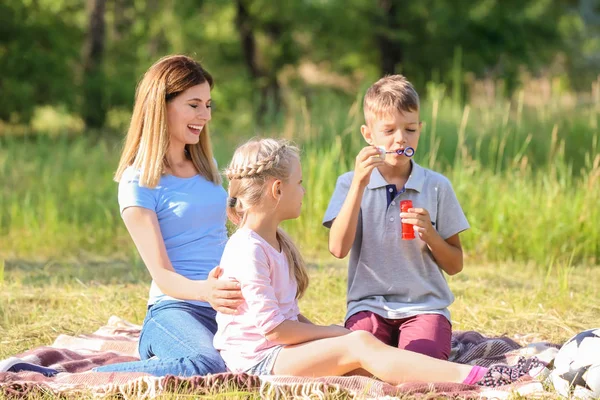 Madre Con Niños Lindos Soplando Burbujas Jabón Parque —  Fotos de Stock