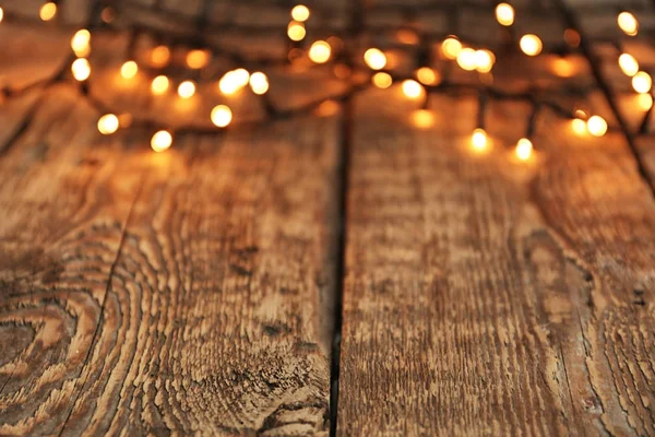 Closeup View Wooden Table Glowing Christmas Lights — Stock Photo, Image
