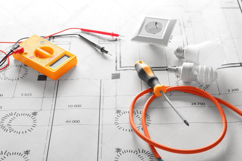 Different electrician's supplies on electrical scheme