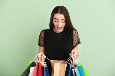 Alışveriş torbaları renk arka plan üzerinde olan duygusal kadın