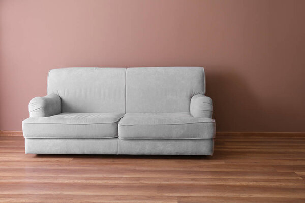 Comfortable sofa near color wall