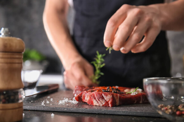 Man preparing meat in kitchen