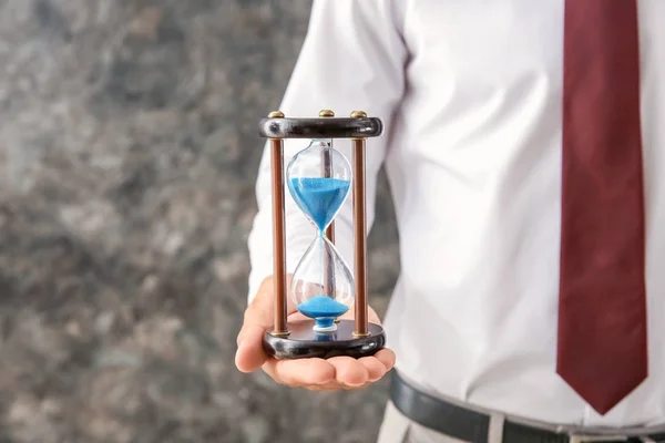 Businessman Holding Hourglass Grey Background Closeup Time Management Concept — Stock Photo, Image